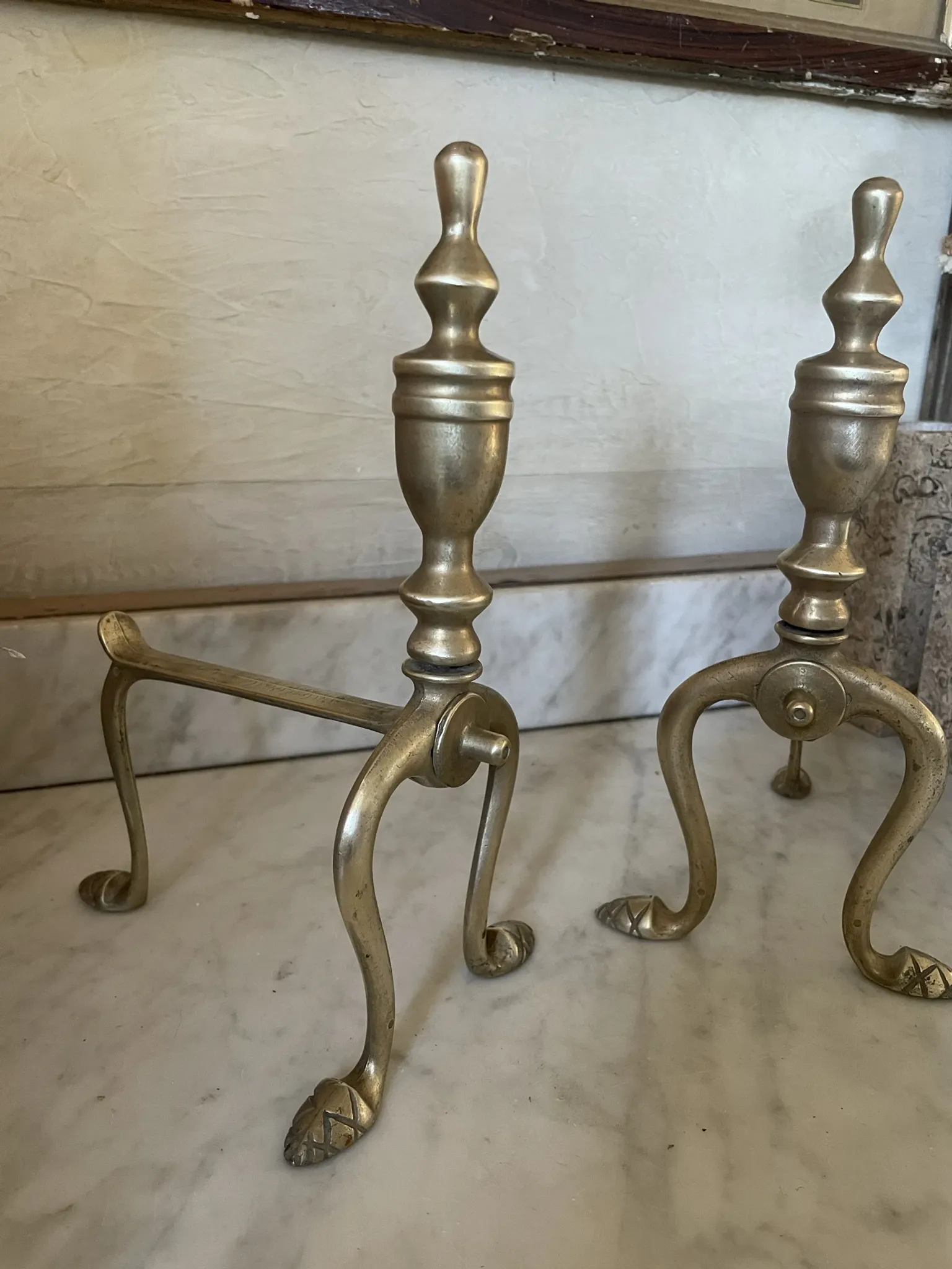 Pair of Victorian brass fire dogs from the late 19th century.