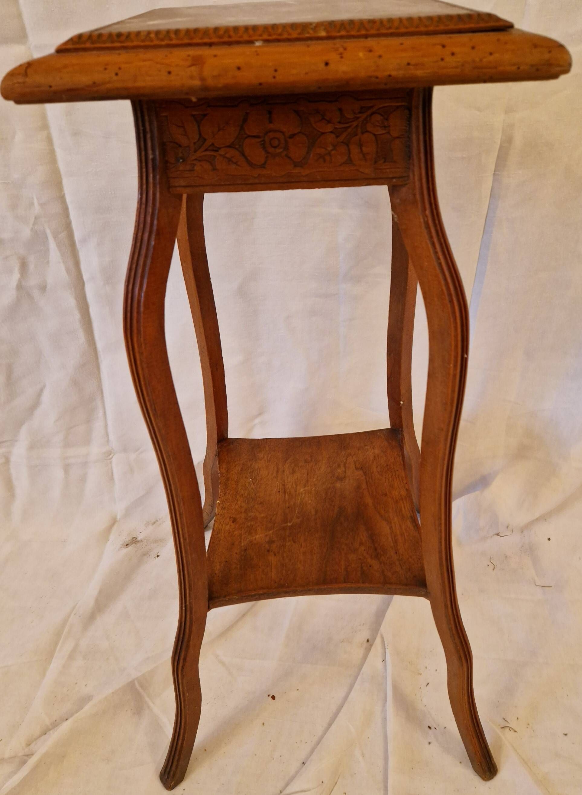 Antique Art Nouveau pedestal table with carved wood and marble top.