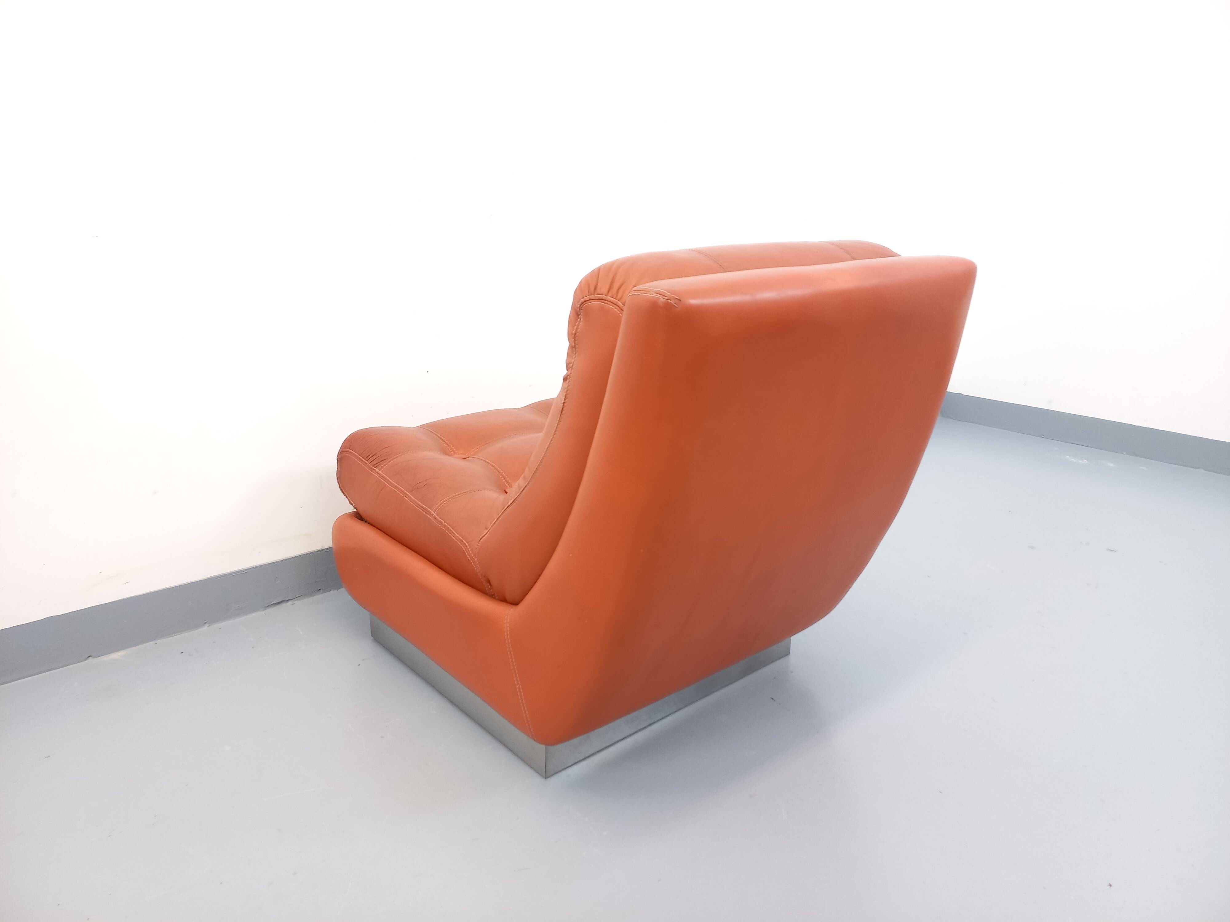 Vintage Roche Bobois armchair in chrome and terracotta leather.