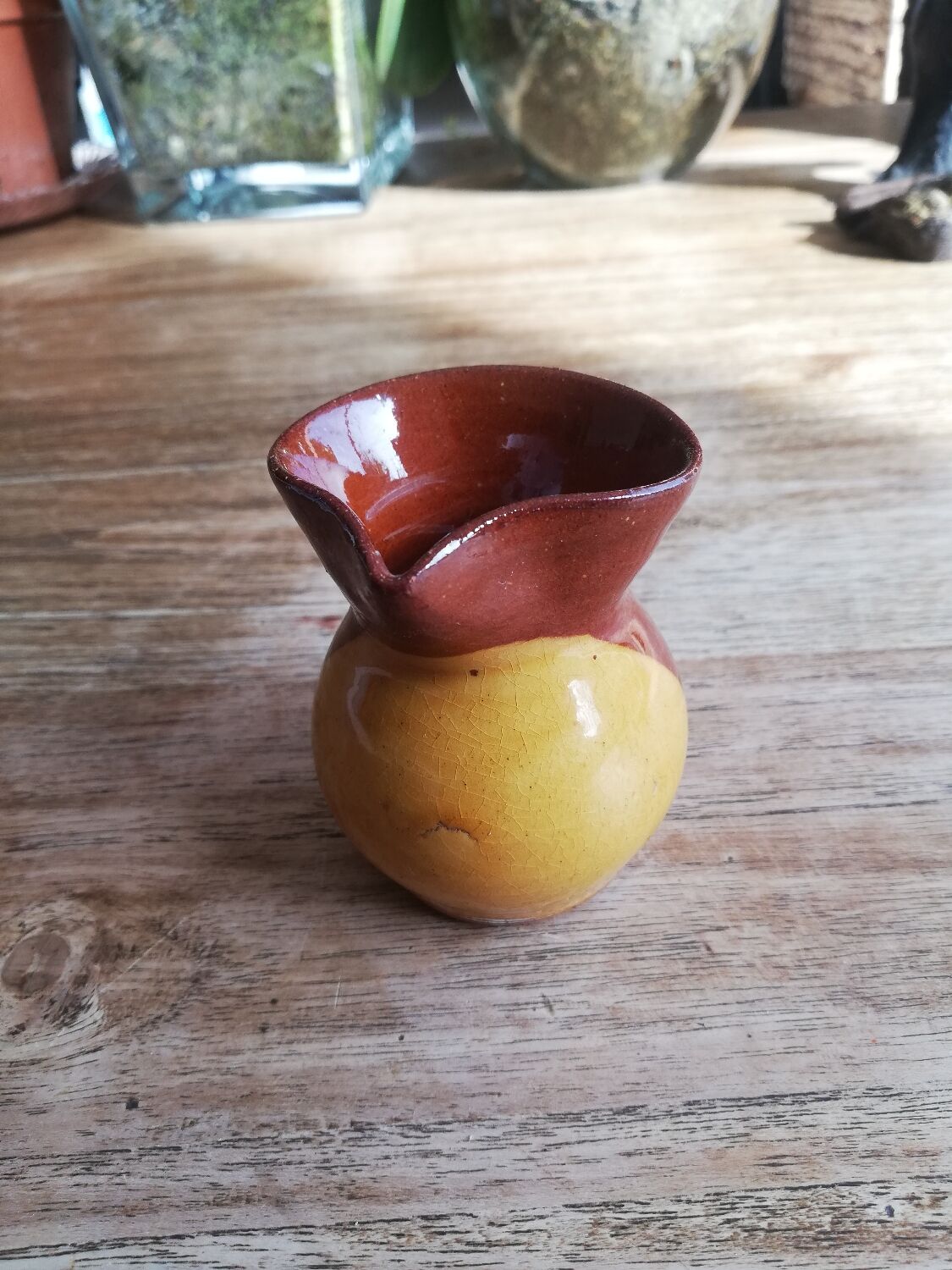 Small two-tone brown-yellow terracotta pitcher