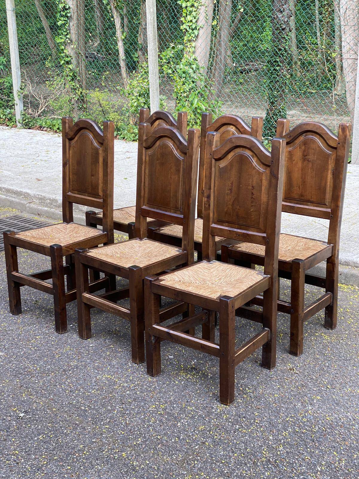 6 dining chairs in a country or farmhouse style, made of dark solid wood and rush-seated.
