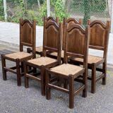6 dining chairs in a country or farmhouse style, made of dark solid wood and rush-seated.