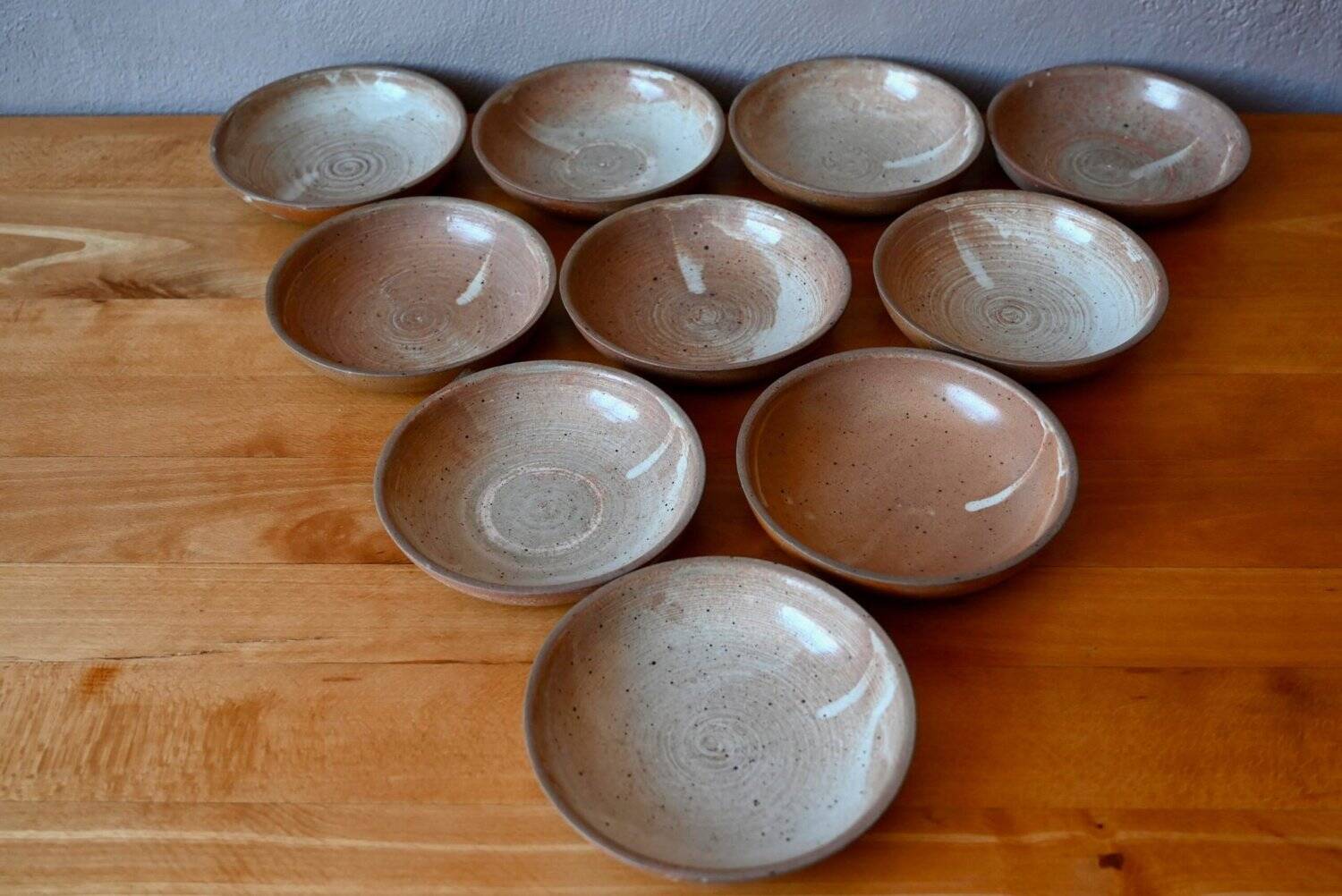 Set of 10 turned stoneware plates, pyritised and glazed, wabi-sabi brutalist.
