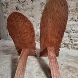 Pair of hand-carved wooden folding chairs – African origin, animal and face motifs, mid-20th century