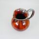 Large red and blue glazed ceramic pitcher signed Delène under the base