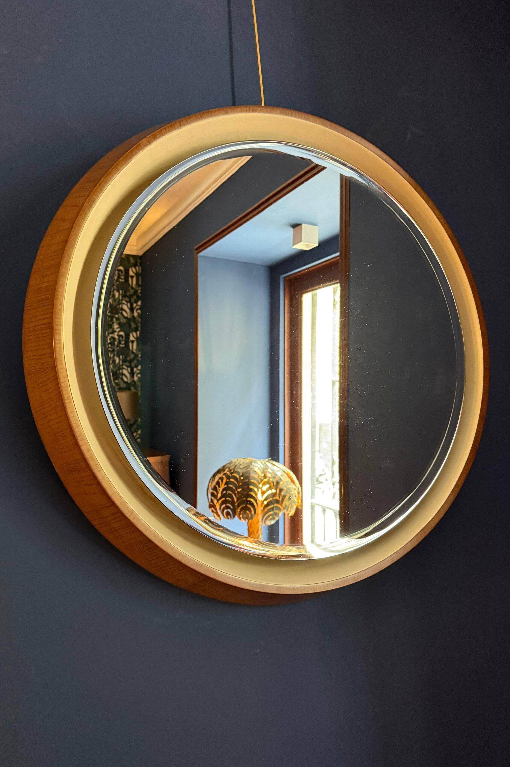 Backlit mirror designed by Gio Ponti in wood and lacquer. Italy, 1970s.