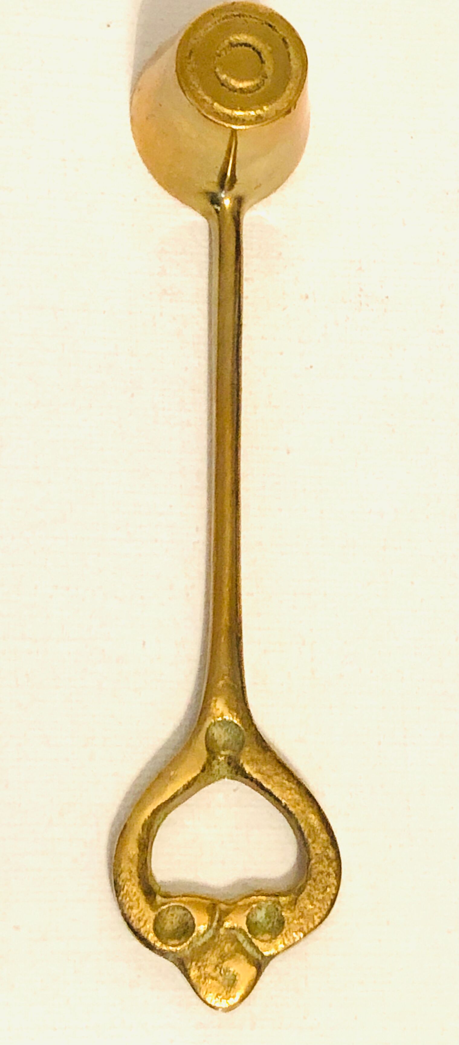 Antique candle extinguisher in golden brass