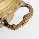 Vintage brass cache-pot on a stand with handles, classic decor.