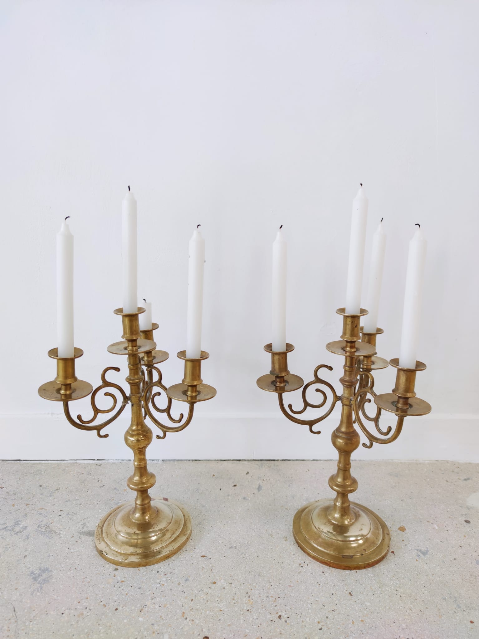 Pair of four-light candle holders in gilded brass