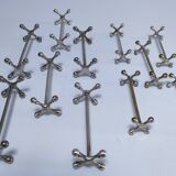 Eleven 70s design metal "crosshair" knife holders