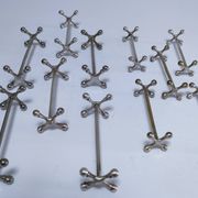 Eleven 70s design metal "crosshair" knife holders