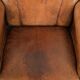 Sheepskin armchair with a beautiful vintage look and decorative nail finish