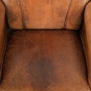 Sheepskin armchair with a beautiful vintage look and decorative nail finish