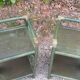 Pairs of bedside tables 2 green rattan shelves