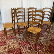 Set of 5 antique solid oak chairs with straw seats.