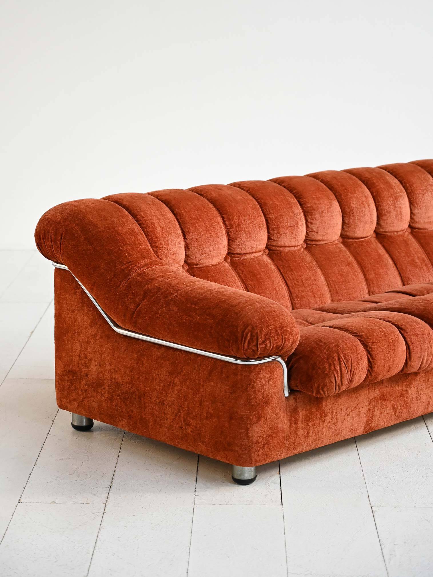 Vintage rust velvet sofa from the 1970s with metal details.