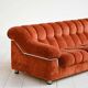 Vintage rust velvet sofa from the 1970s with metal details.