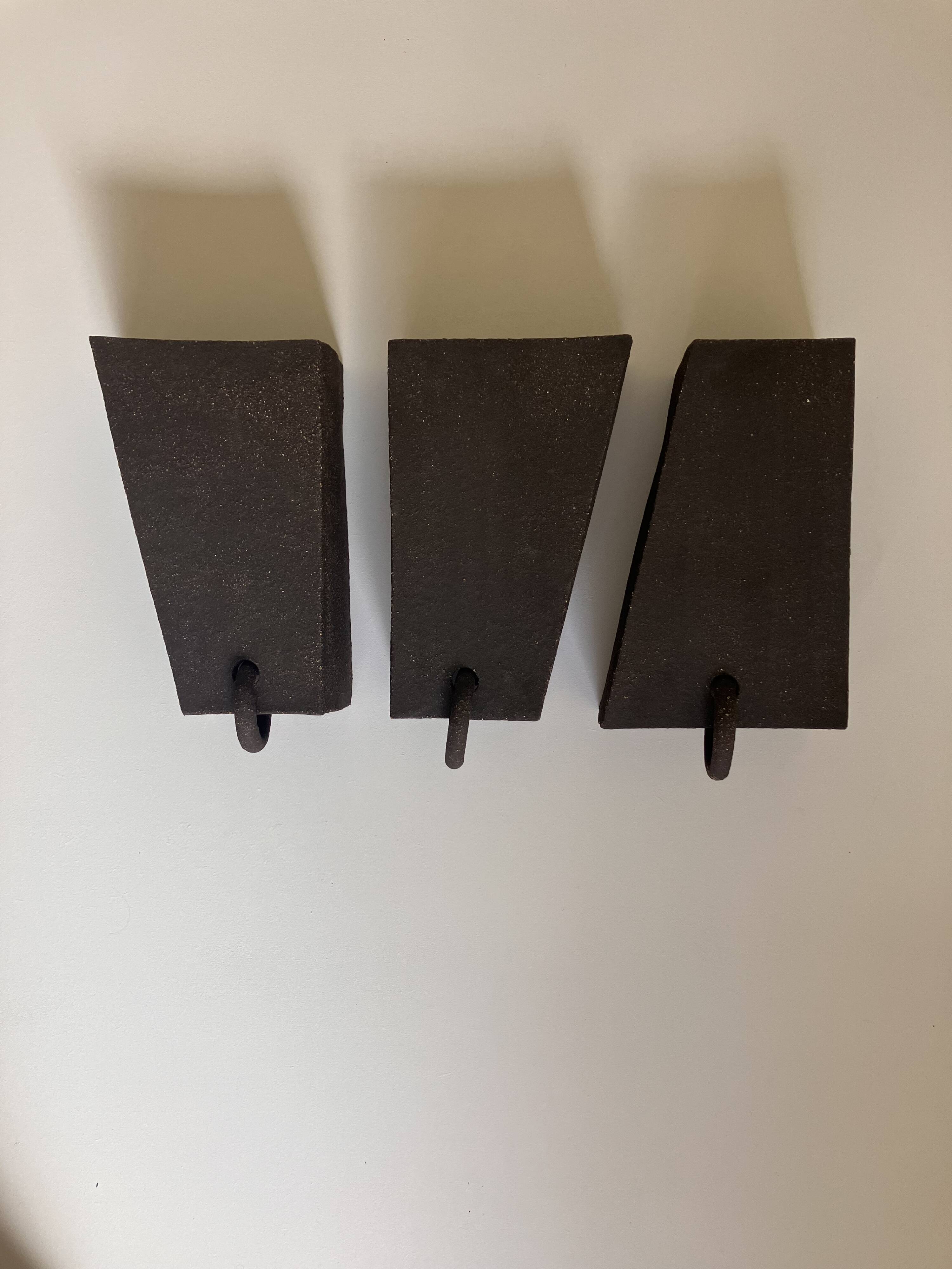 Graphical black stoneware ceramic wall light with handmade ring.