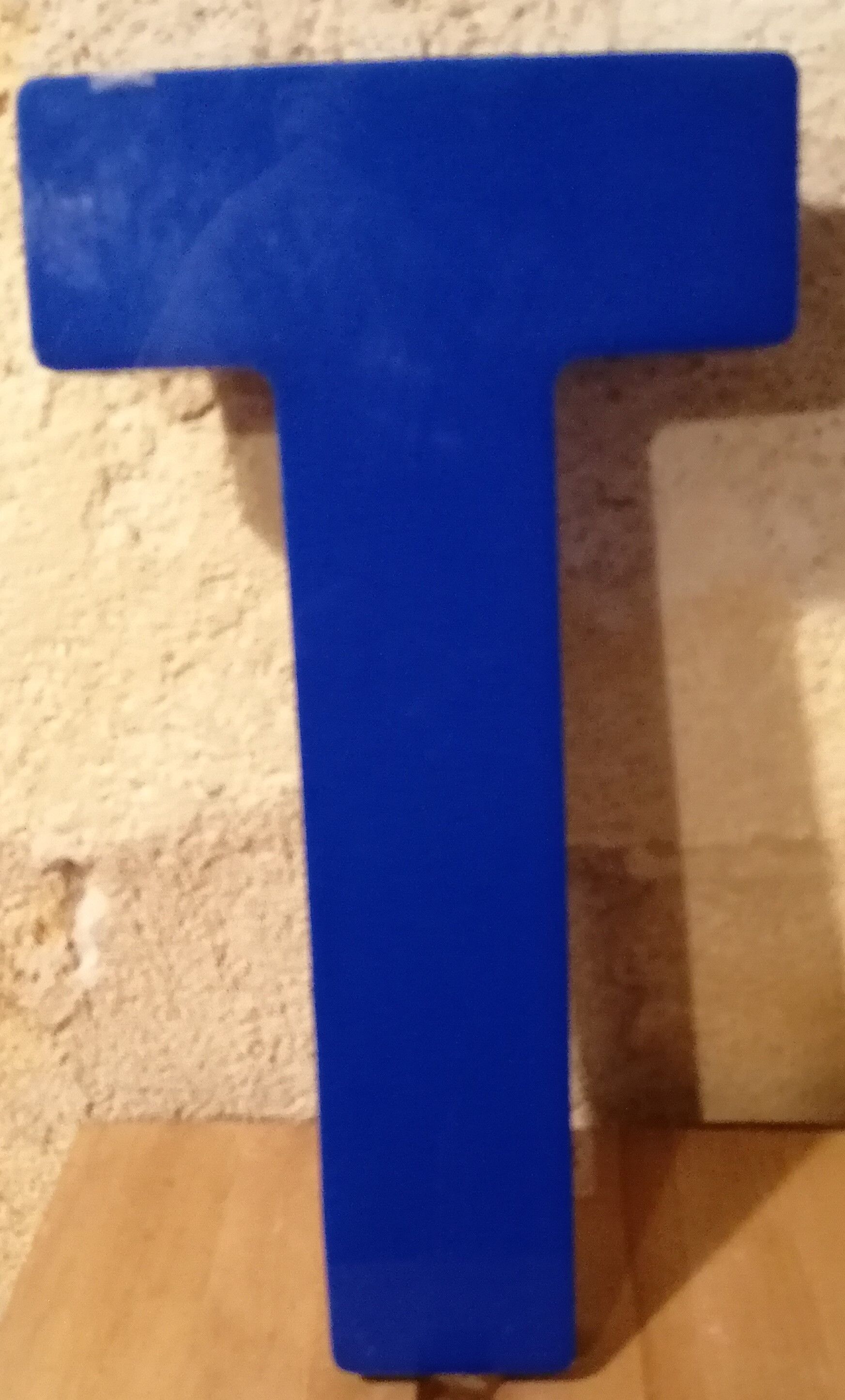 Vintage sign letter T in blue plexiglass
