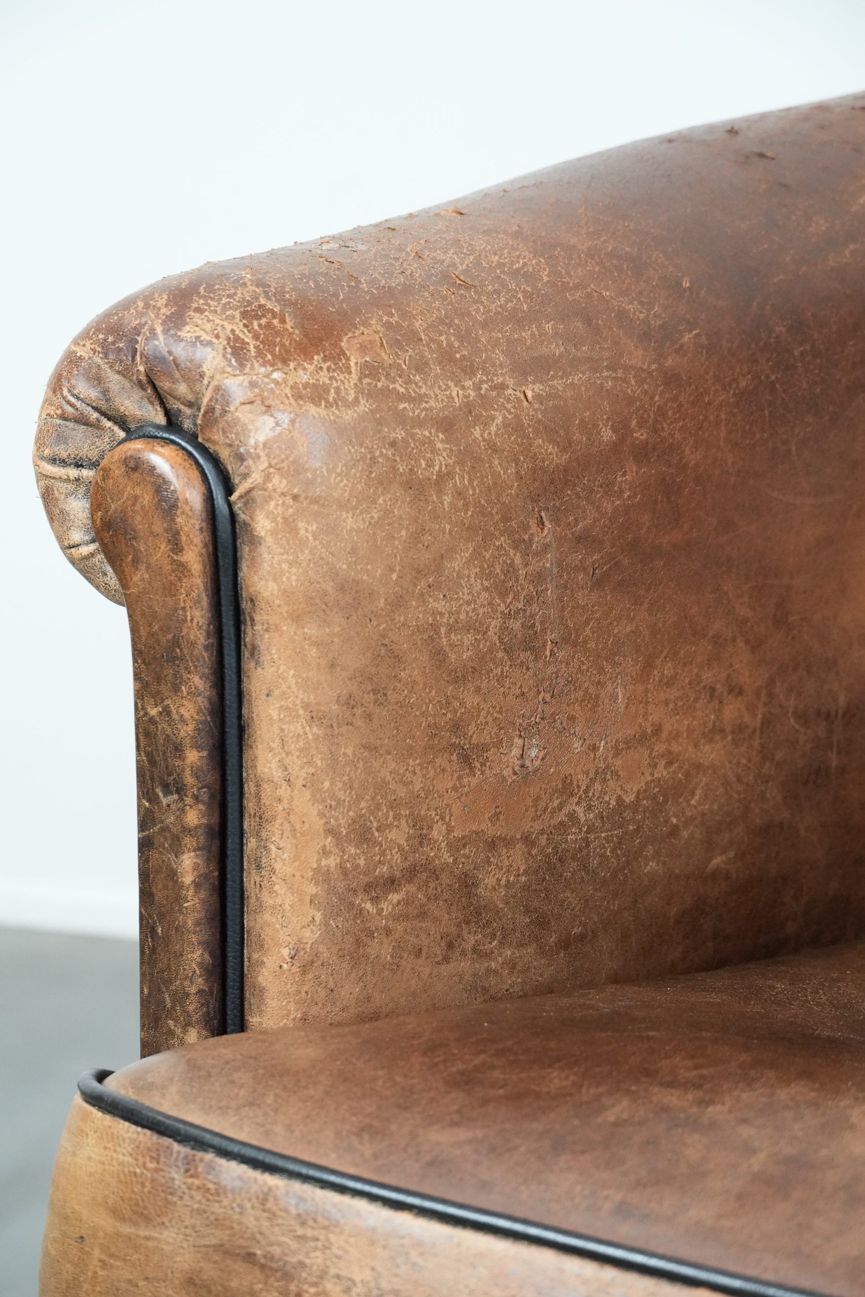 Sturdy vintage sheepskin club armchair with a beautiful patina