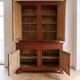 Antique solid wood sideboard with doors and drawers.