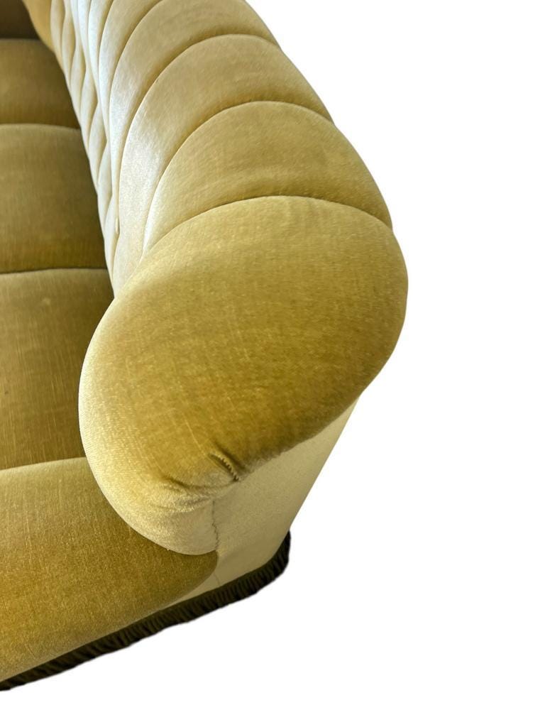 Vintage yellow-green fringed three-seater sofa