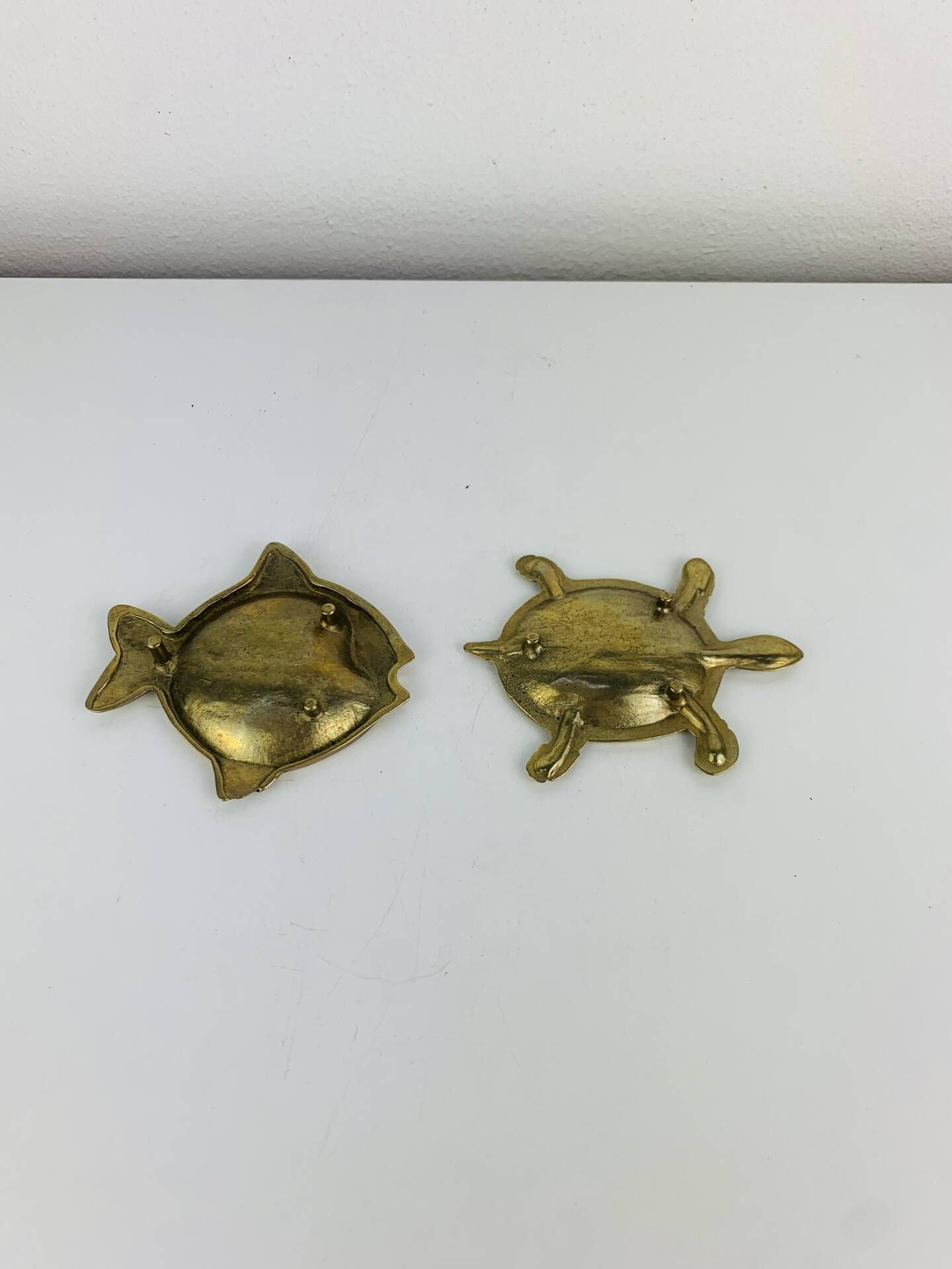 Pair of animal trinket trays in brass, fish and turtle.