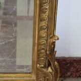 Large 19th-century wooden and gilt-studded mirror decorated with a cornucopia motif.