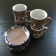 Set of 4 brown stoneware mugs and saucers with blue decor