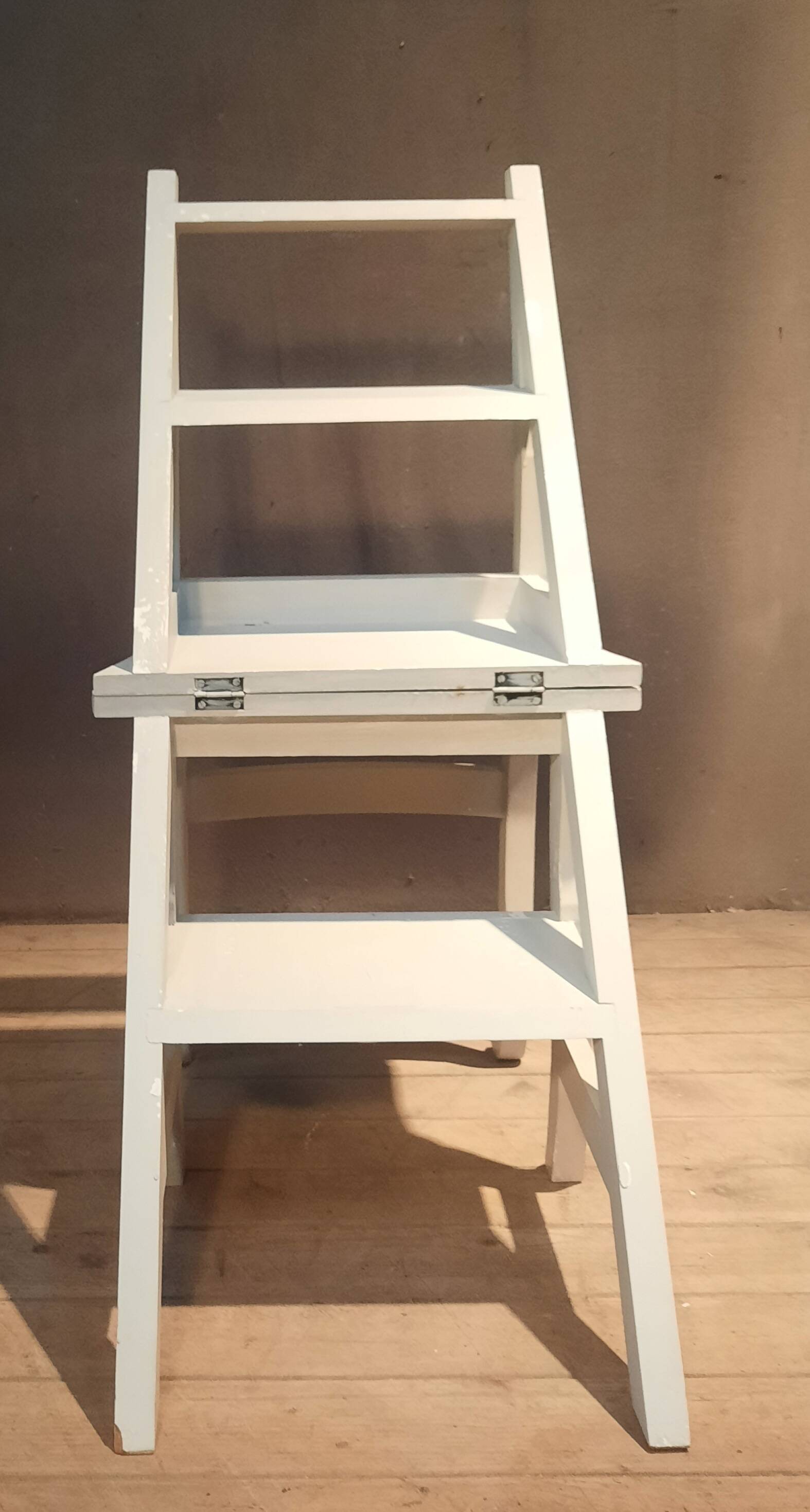 White chair convertible into a staircase.
