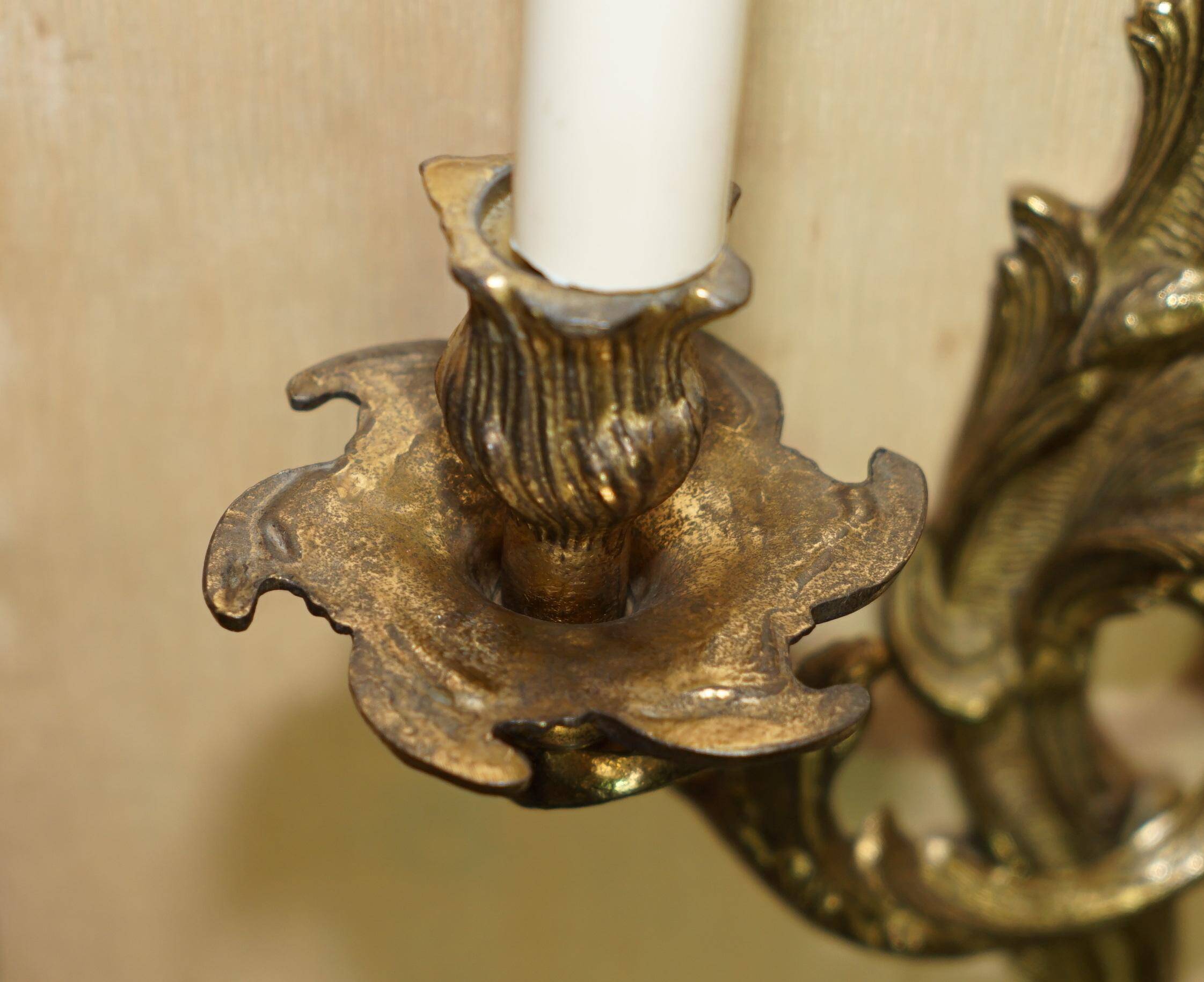 Pair of antique wall sconces from the 1920s in gilded bronze.