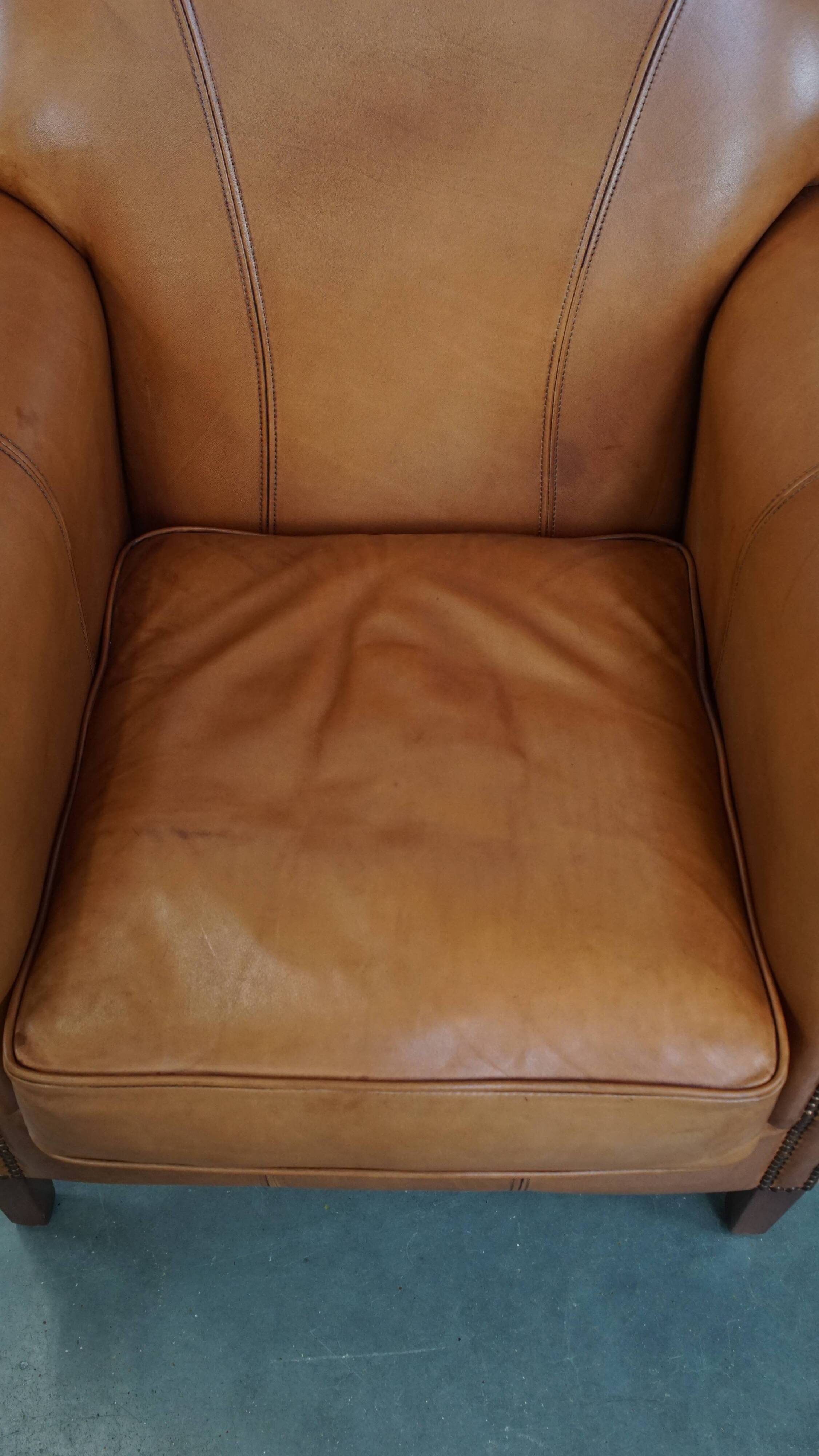 Cognac-colored cowhide leather armchair