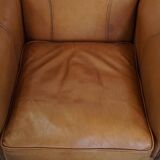 Cognac-colored cowhide leather armchair