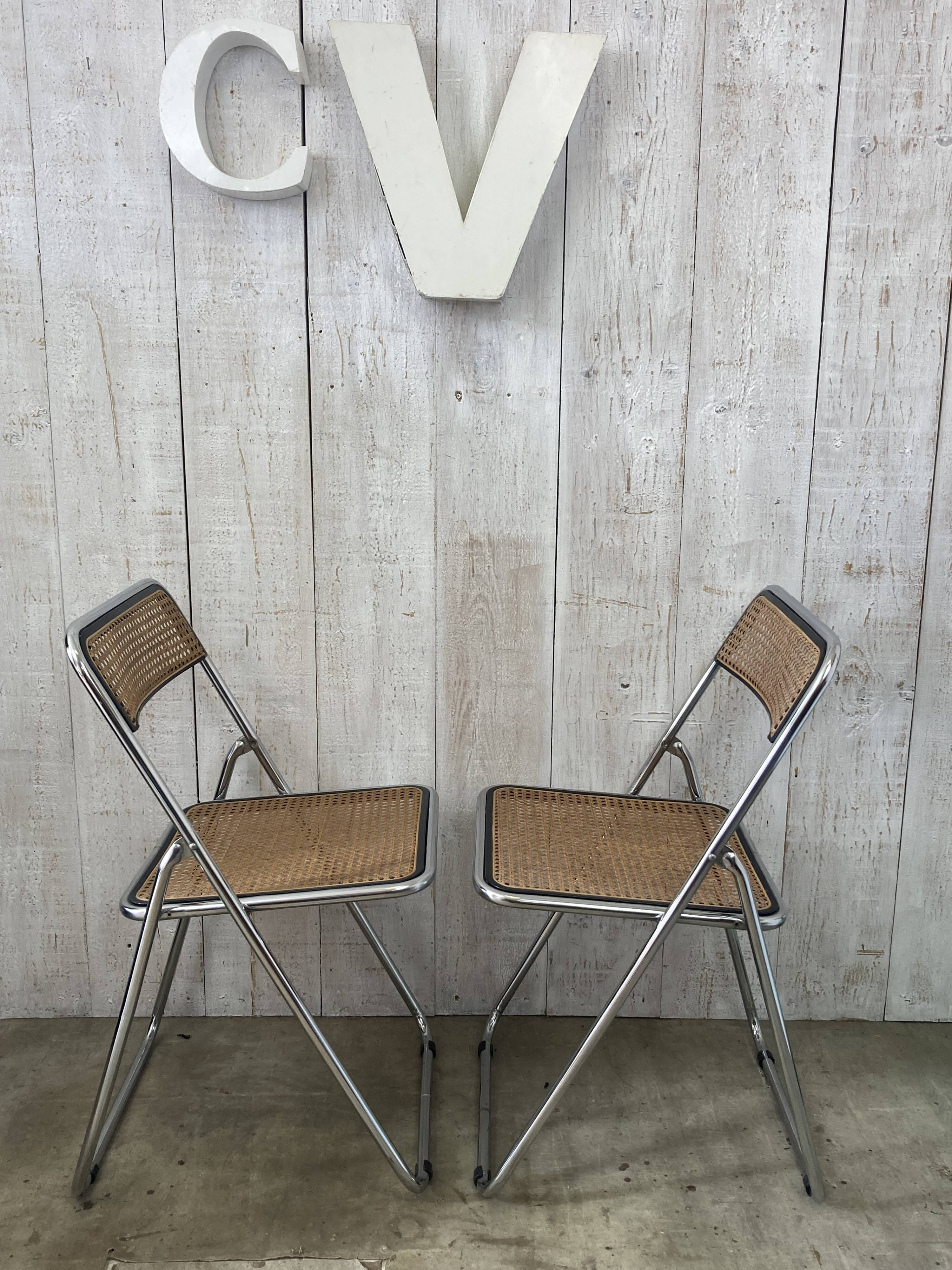 Pair of chrome and cane folding chairs