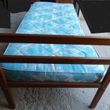 Single bed with wooden headboard and footboard and metal box spring