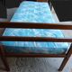 Single bed with wooden headboard and footboard and metal box spring