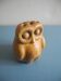 vintage earthenware vase with an old flower pick and an owl decoration