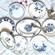 Mismatched antique flat plates accompanied by dishes.
