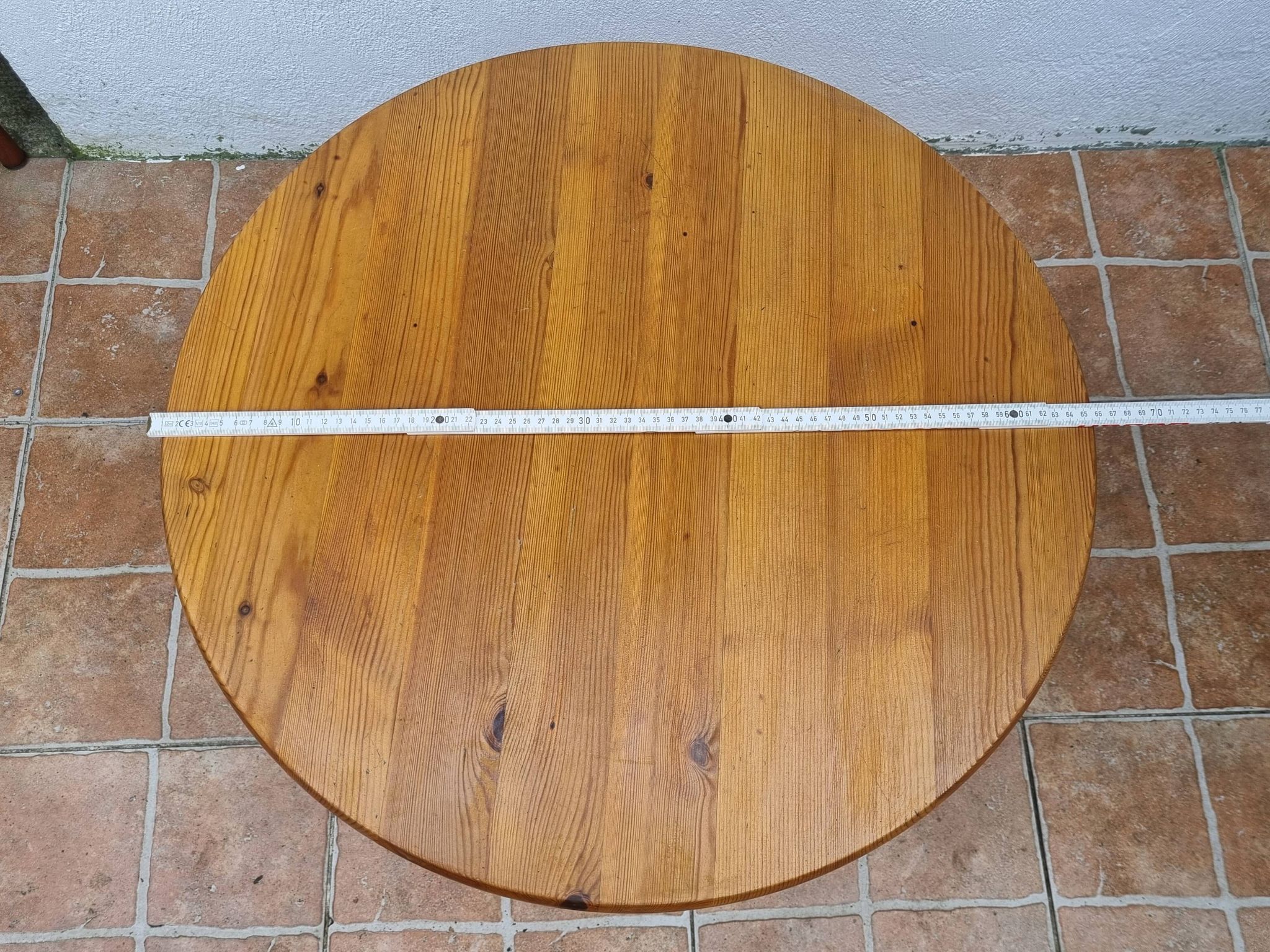 Scandinavian coffee table in solid pine with tripod legs in Swedish chalet style.