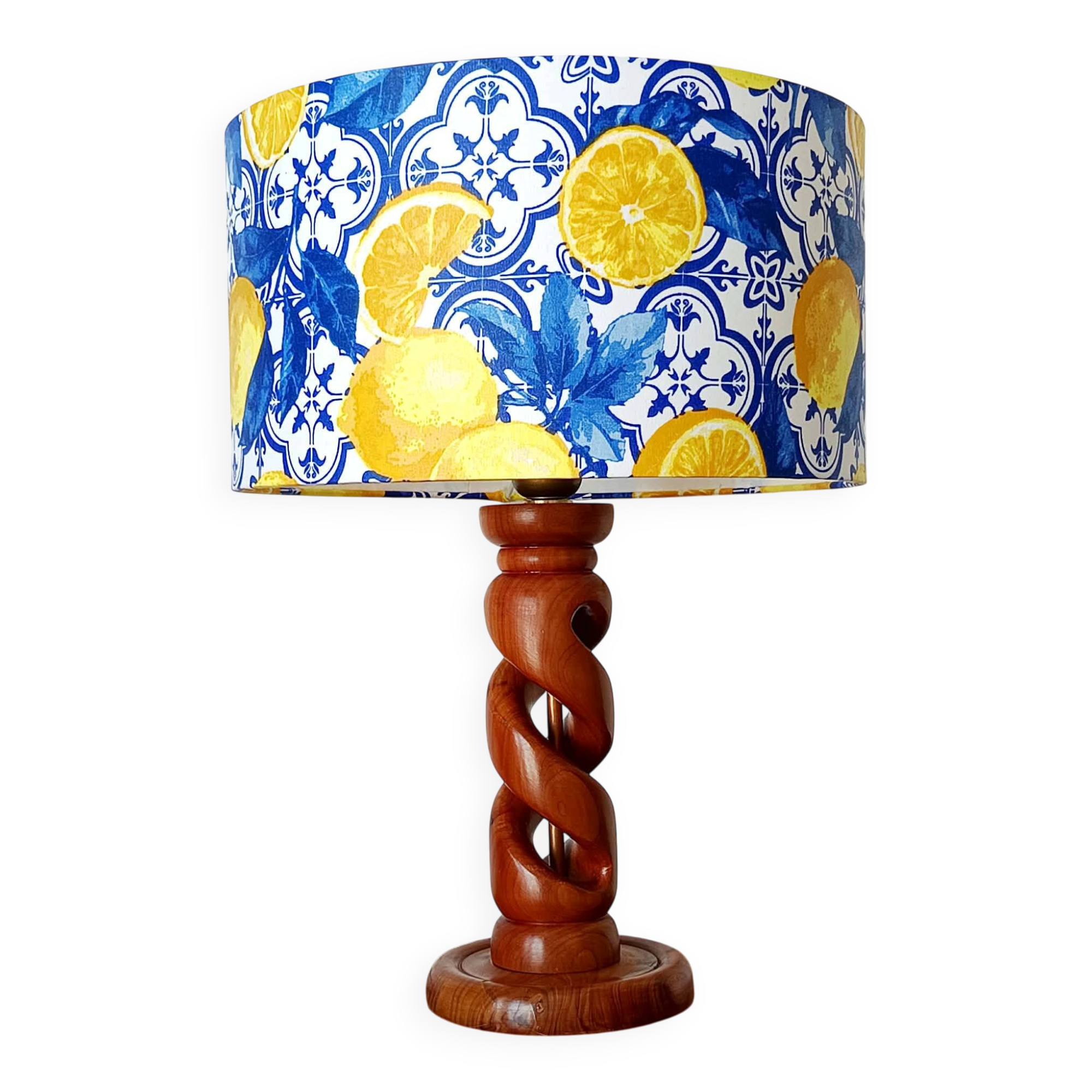 Turned wooden lamp with a lampshade featuring lemon tiles.