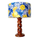 Turned wooden lamp with a lampshade featuring lemon tiles.