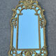Large mirror with carved and gilded wooden frame, in Regency style.