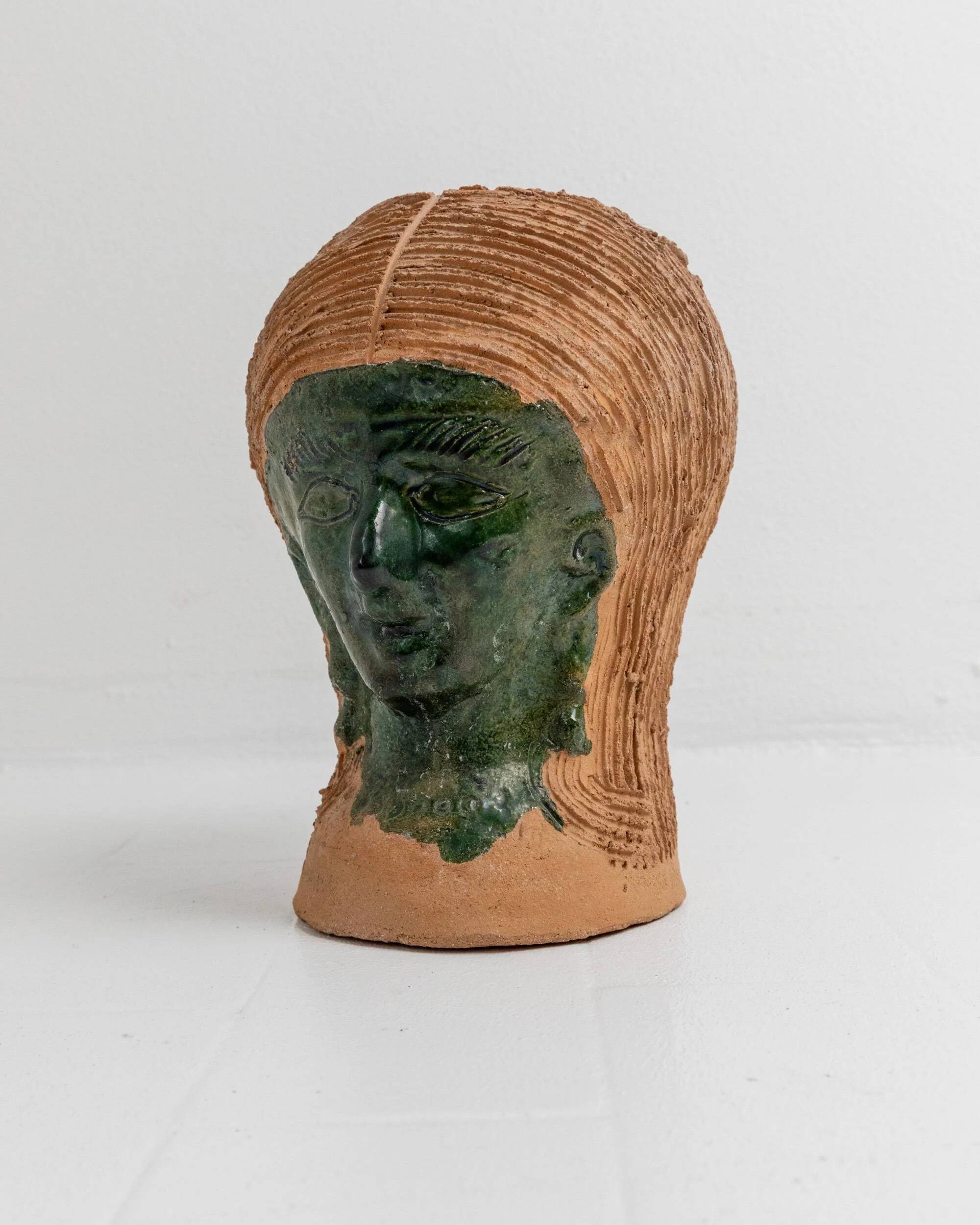 Vintage ceramic vase from the 1980s, sculptural head shape with a green glazed face, terracotta art object.