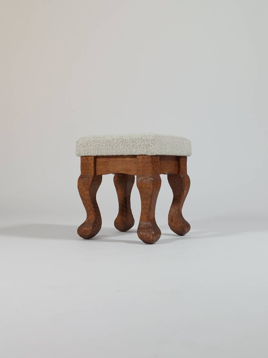 Unique sculpted stools, freshly upholstered and exquisite.