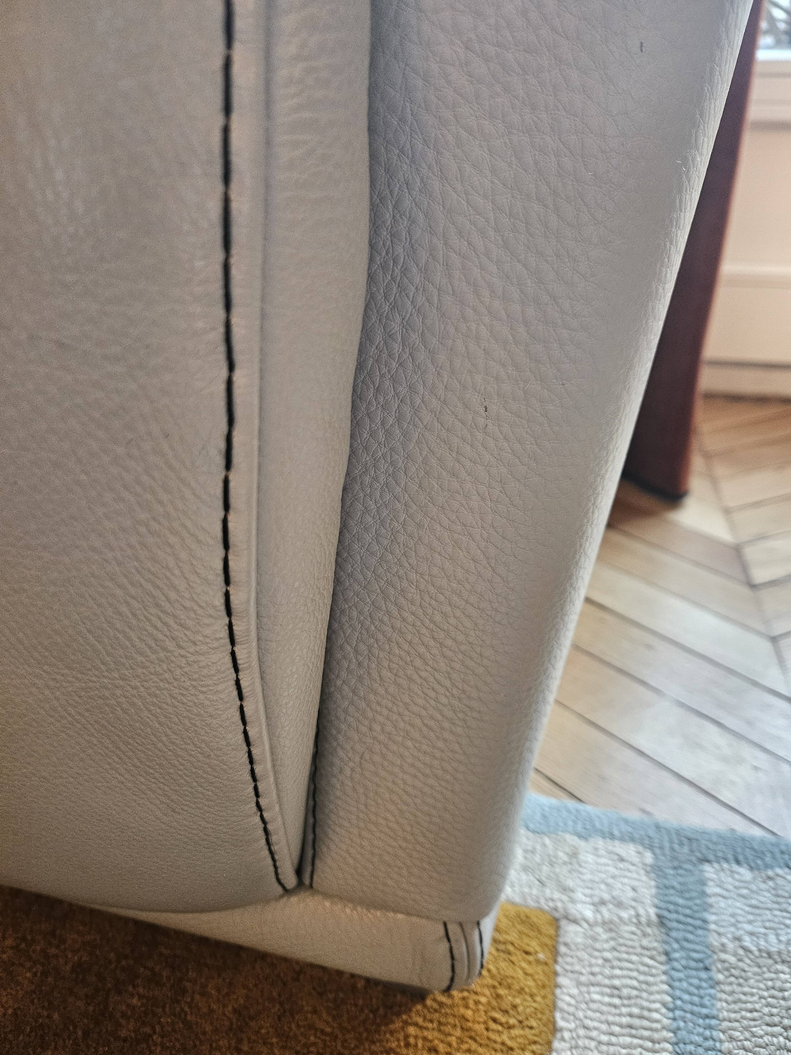 Two-seater sofa and a grey leather armchair Italia.