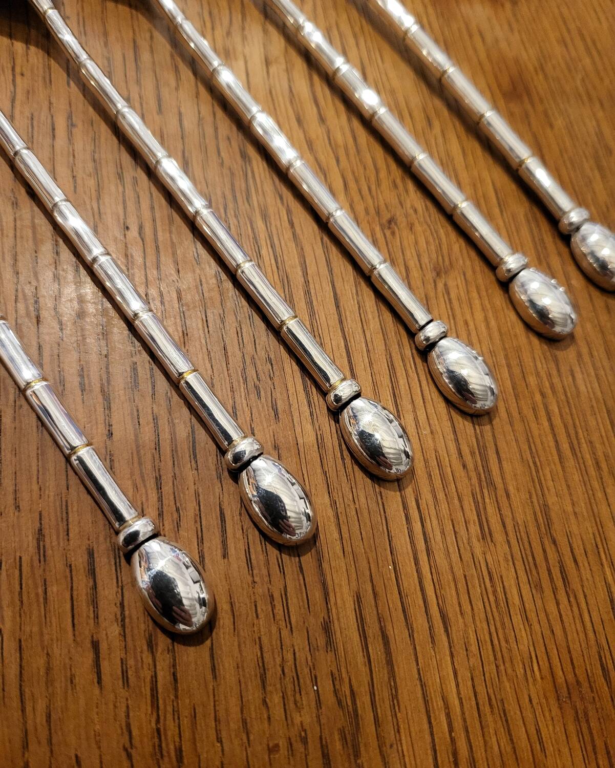 6 long silver-plated metal spoons