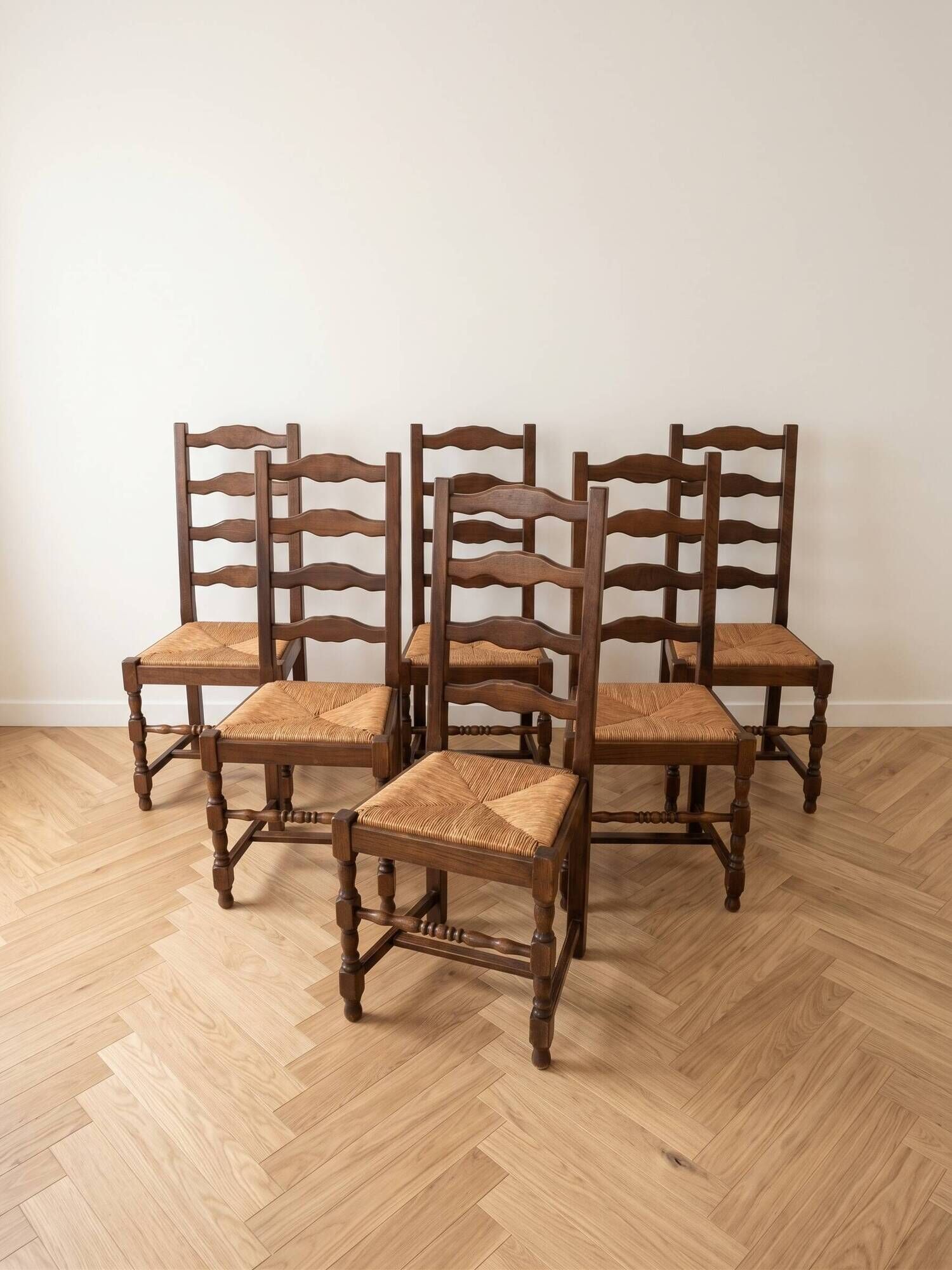 Set of 6 rustic wooden chairs with woven straw.