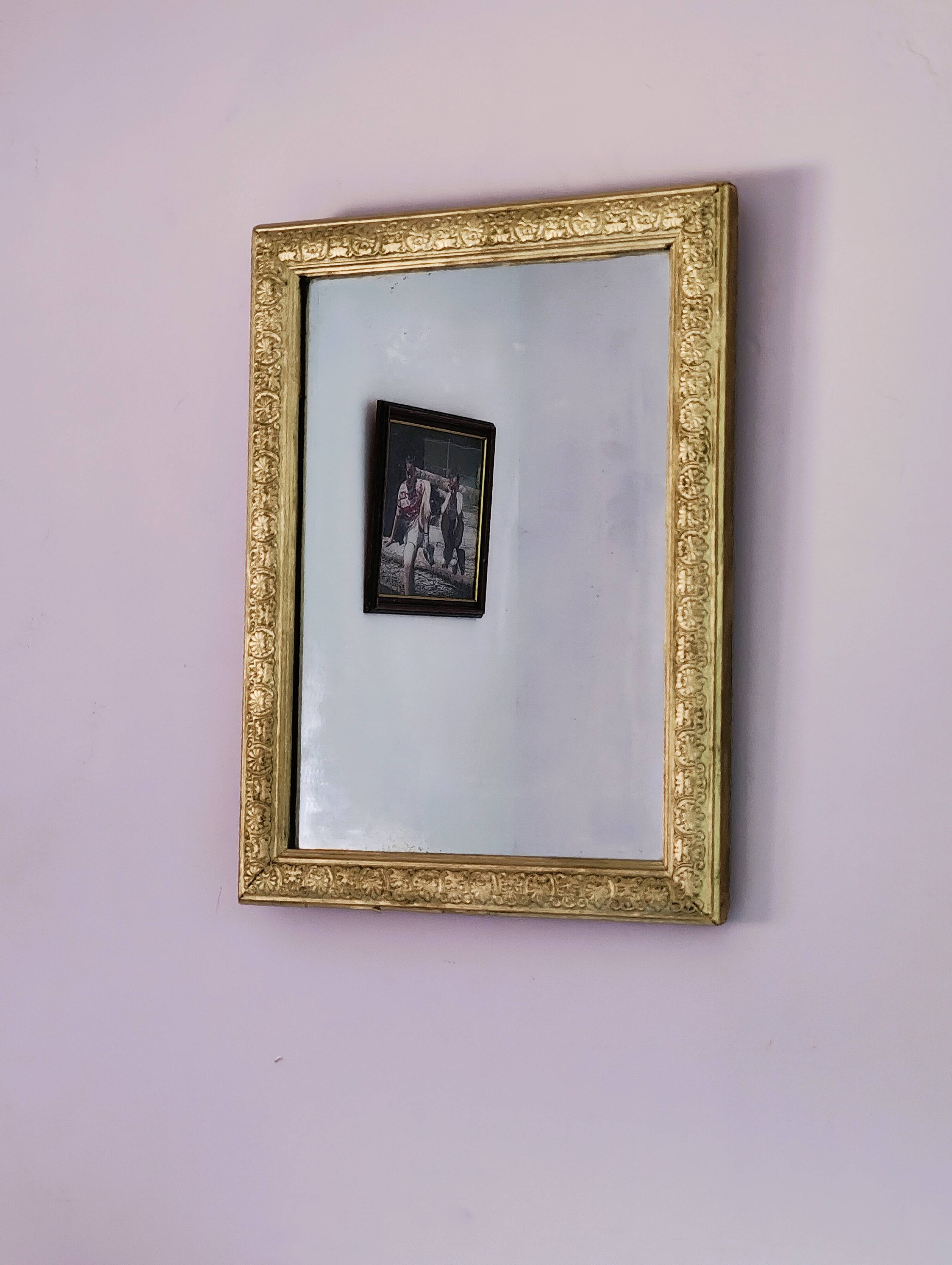 Rectangular wooden mirror with ornate Art Nouveau gold finish.