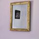 Rectangular wooden mirror with ornate Art Nouveau gold finish.