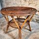 Vintage rattan lounge set, French wicker armchairs and round table, circa 1930–1950.